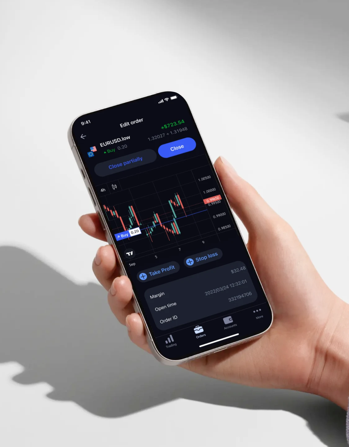 A hand holding a phone with the Octatrader app open on an order, against a light grey wall