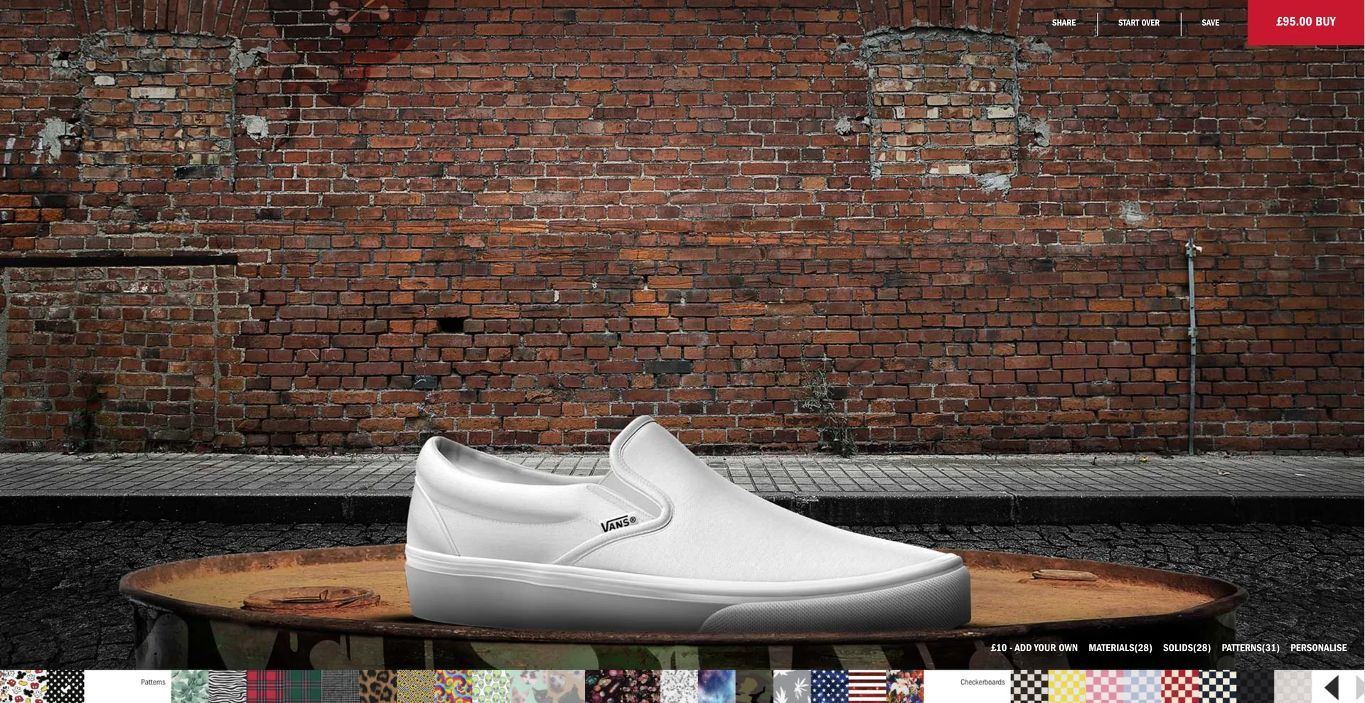 A white slip-on on a wooden table in front of an empty brick wall